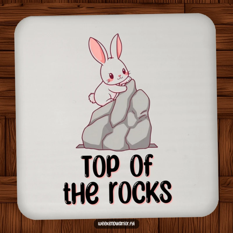 Funny kawaii rabbit with determined paws scaling a miniature rock face, printed on a protective drink coaster. Adds humor and adventure.