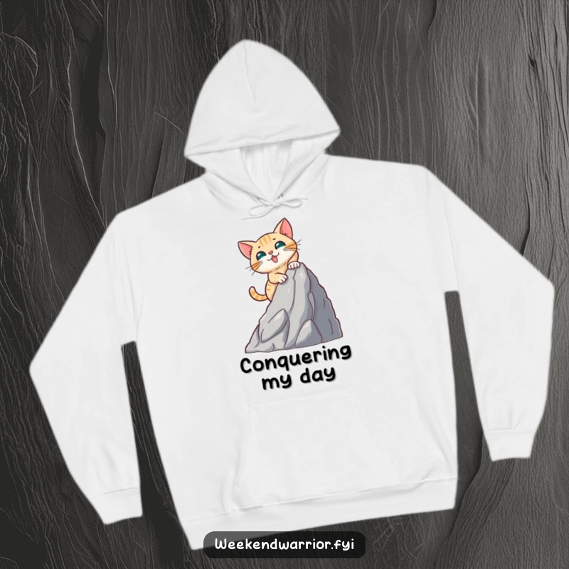 Funny hoodie graphic of a brave cat energetically ascending a small artificial mountain, embodying feline courage.
