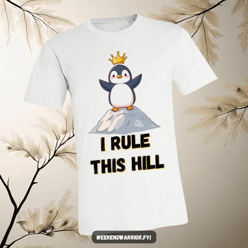Funny t-shirt depicting a proud penguin standing majestically on a small summit, looking out over its territory.