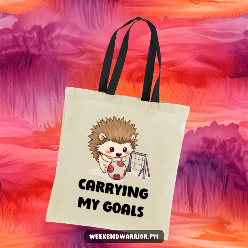 Funny tote bag showing a determined hedgehog rolling a small ball towards a makeshift goal, great for carrying items.
